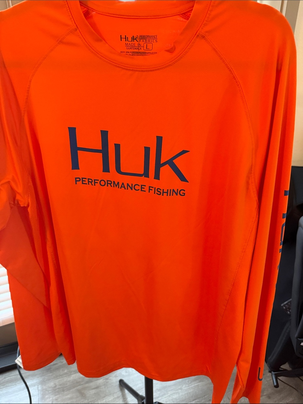 Huk Men's Long Sleeve Performance Rash Guard - Orange with Blue Logo